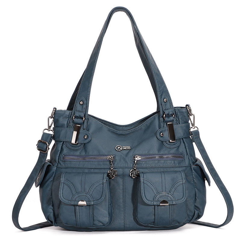 Blue handbag with multiple pockets and straps on a white background