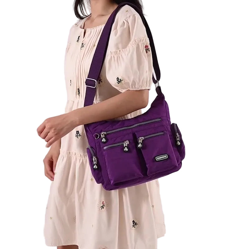 Person wearing a purple shoulder bag on a white background