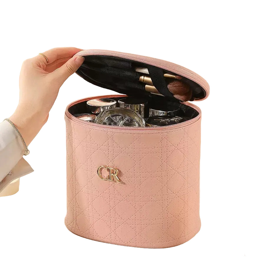 Pink makeup organizer with cosmetic items on a white background