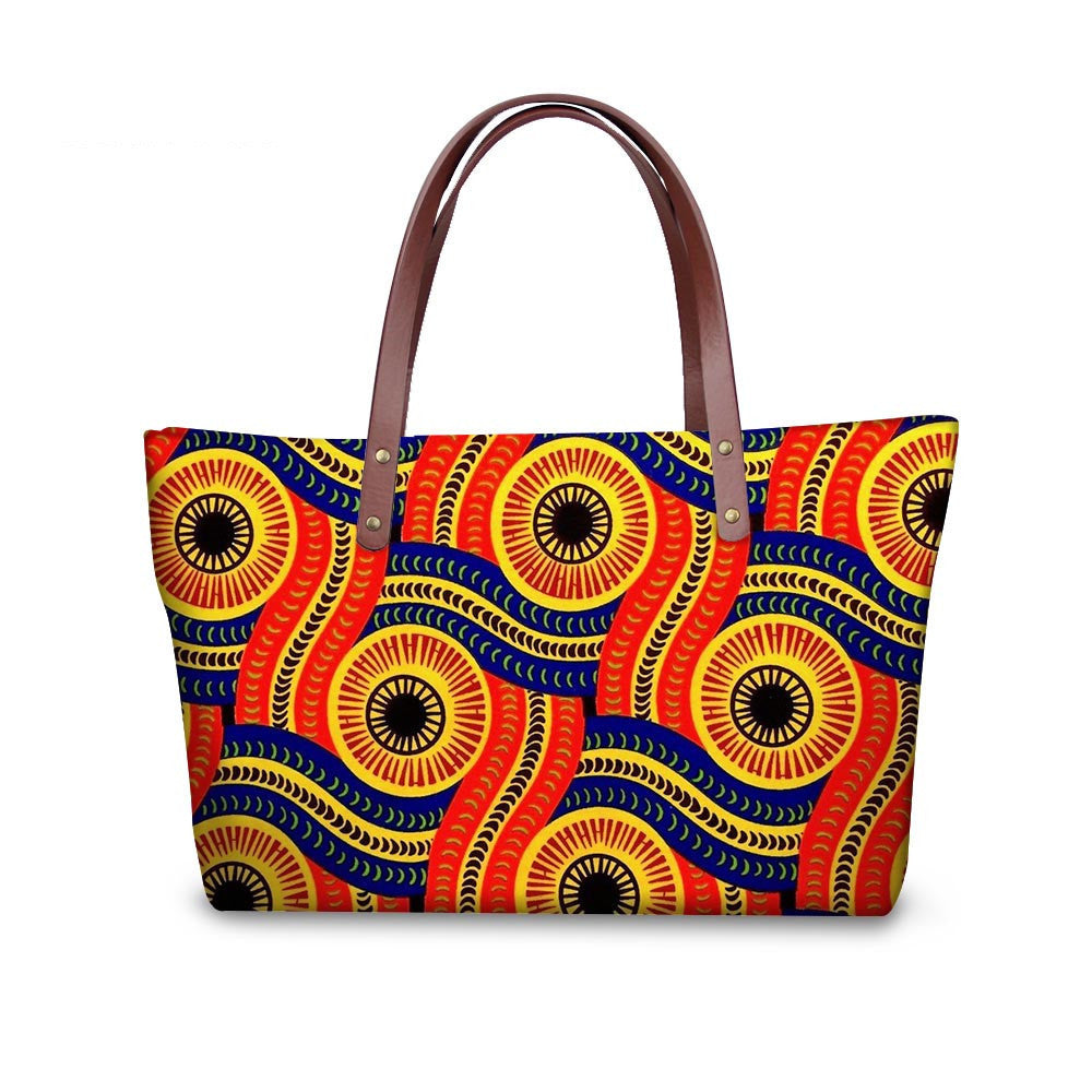 Colorful patterned handbag with brown handles on a white background