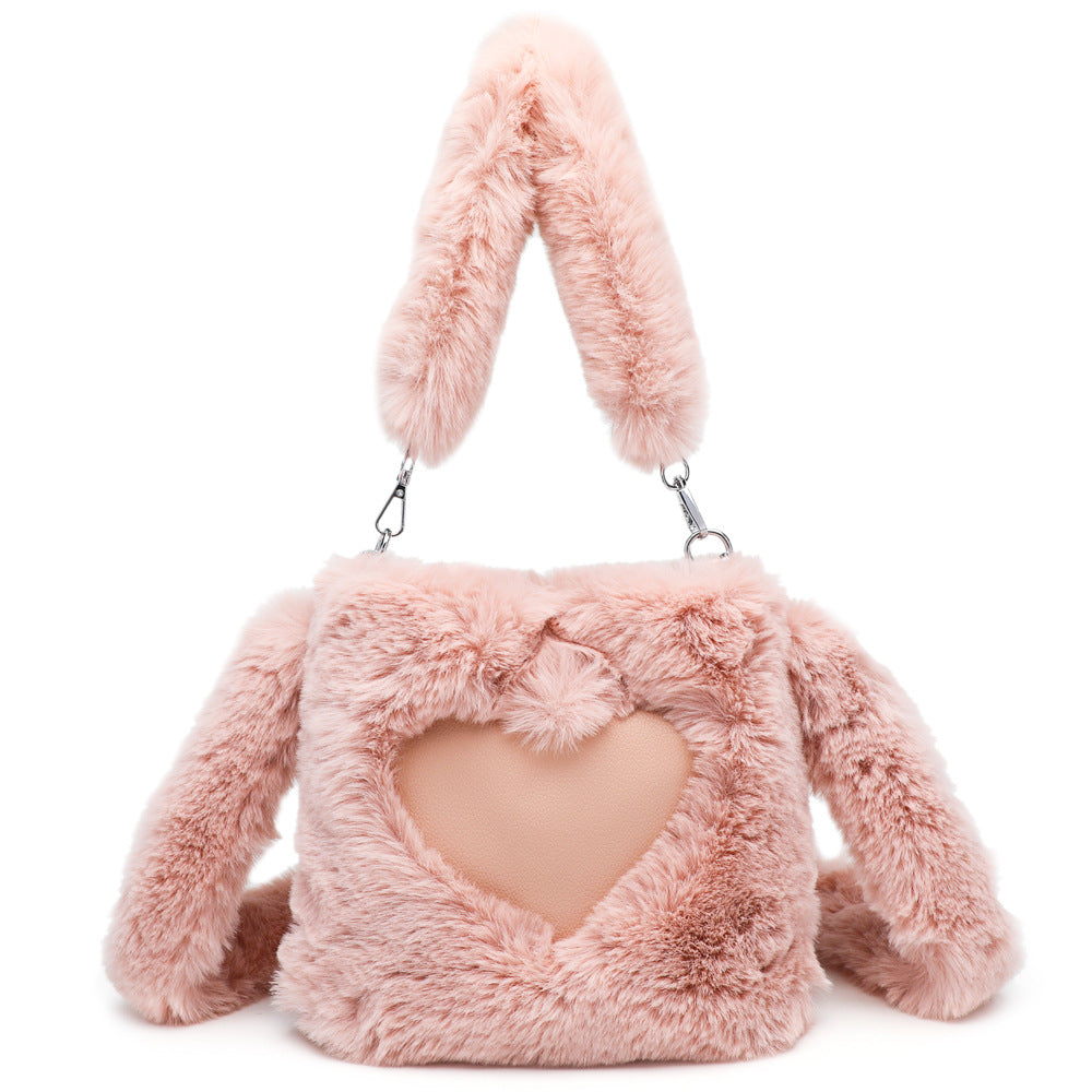 Pink fluffy bunny bag with heart detail on a white background