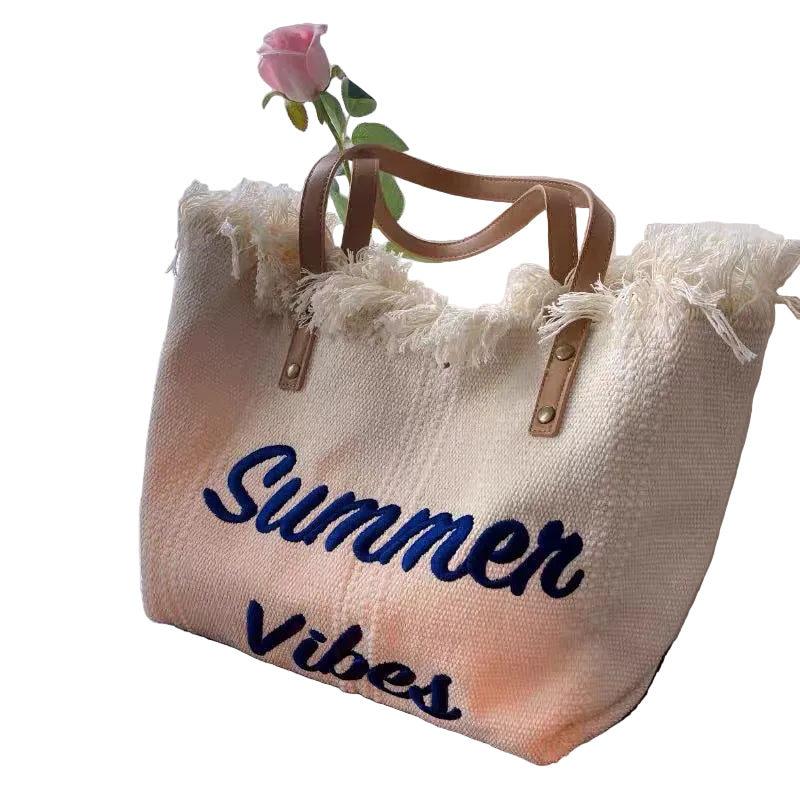 Beige tote bag with 'Summer Vibes' text on a white background