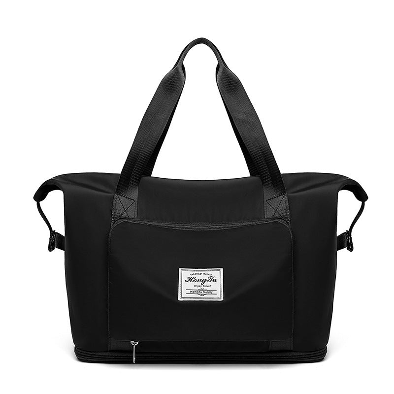 Black duffel bag with a visible brand label on a white background