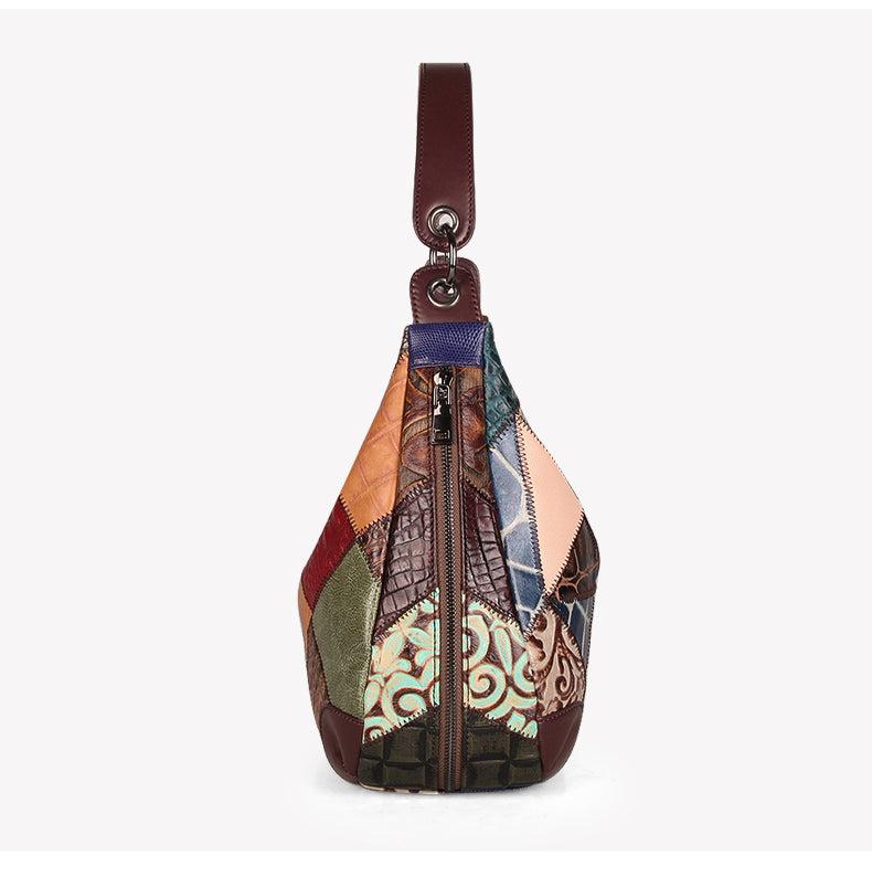 Multicolored patchwork sling bag with a brown strap on a white background