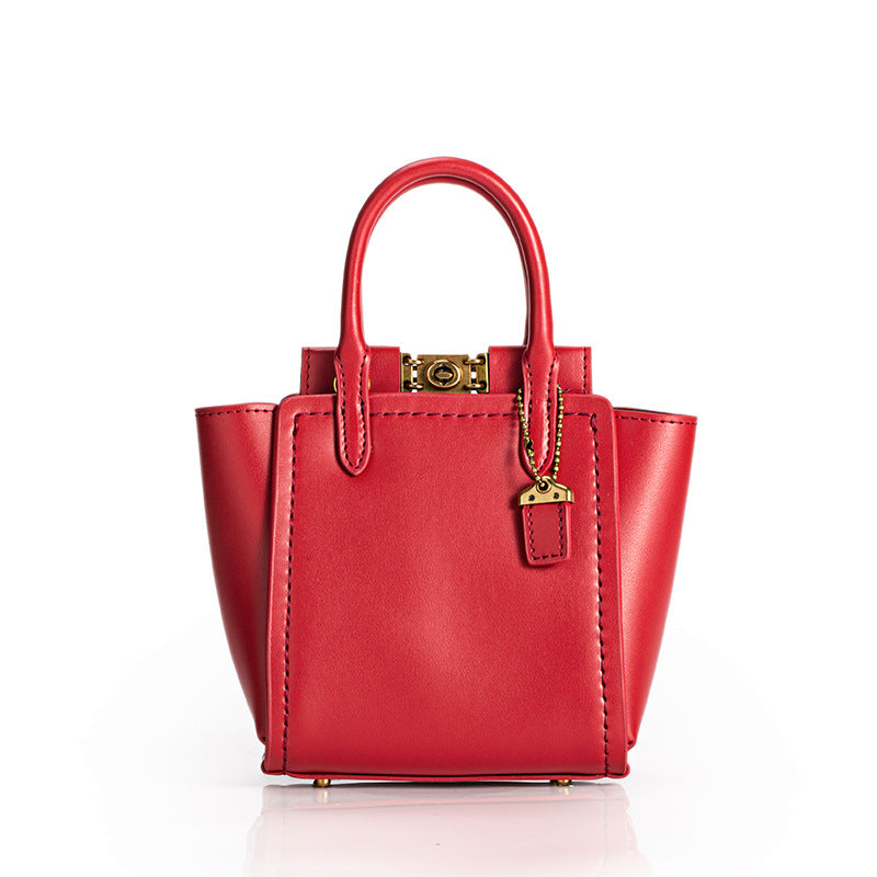 Red handbag with gold accents on a white background