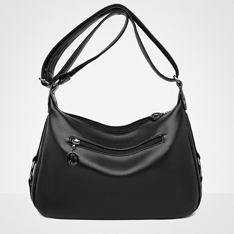 Black handbag with a shoulder strap on a white background