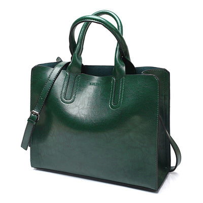Green handbag with a shoulder strap on a white background