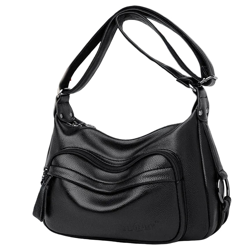Black handbag on a surface on a white background