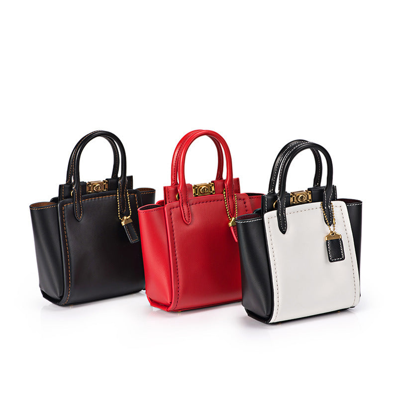 Three handbags in black, red, and white on a white background