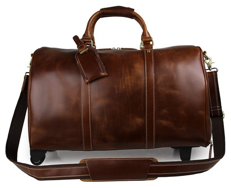Brown leather duffel bag with wheels on a white background
