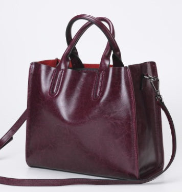 Burgundy handbag on a light gray background