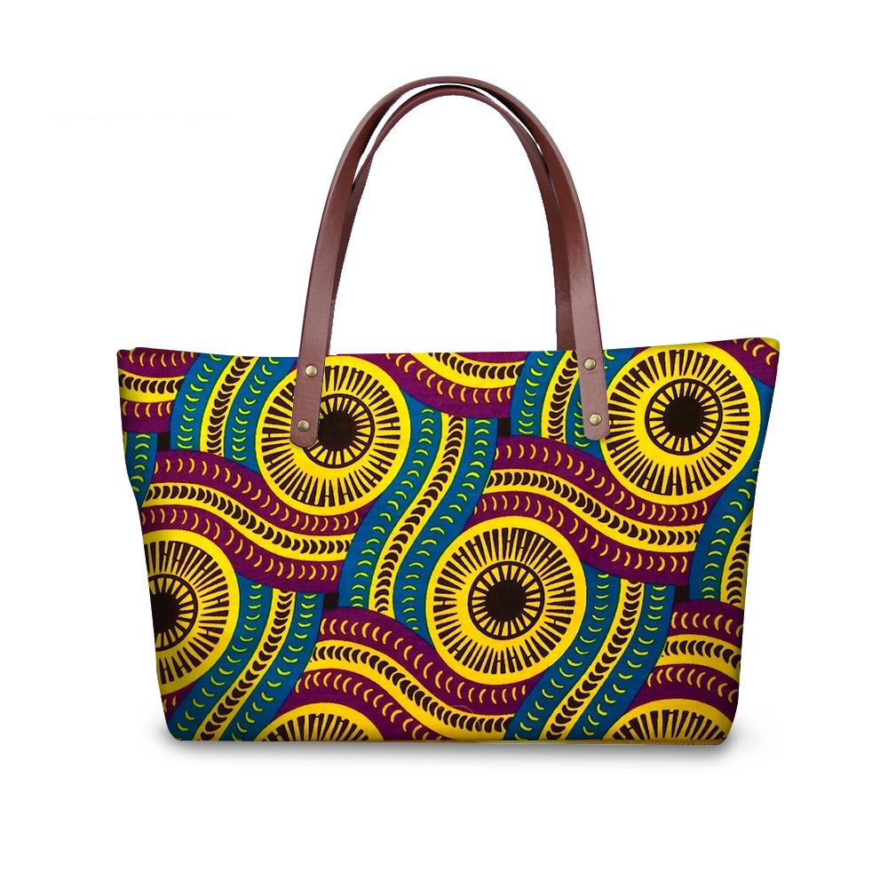 Colorful patterned handbag with brown handles on a white background
