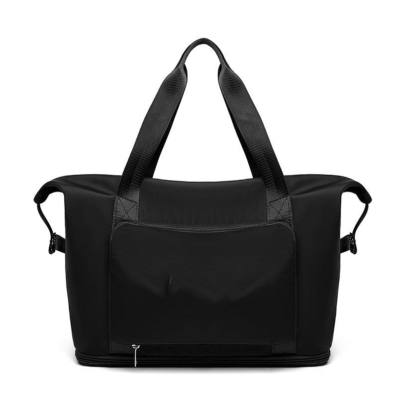 Black duffel bag with shoulder straps on a white background