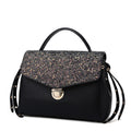 Black handbag with glittery flap on a white background