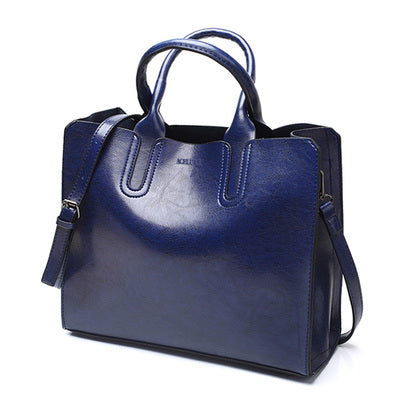 Blue handbag with a strap on a white background