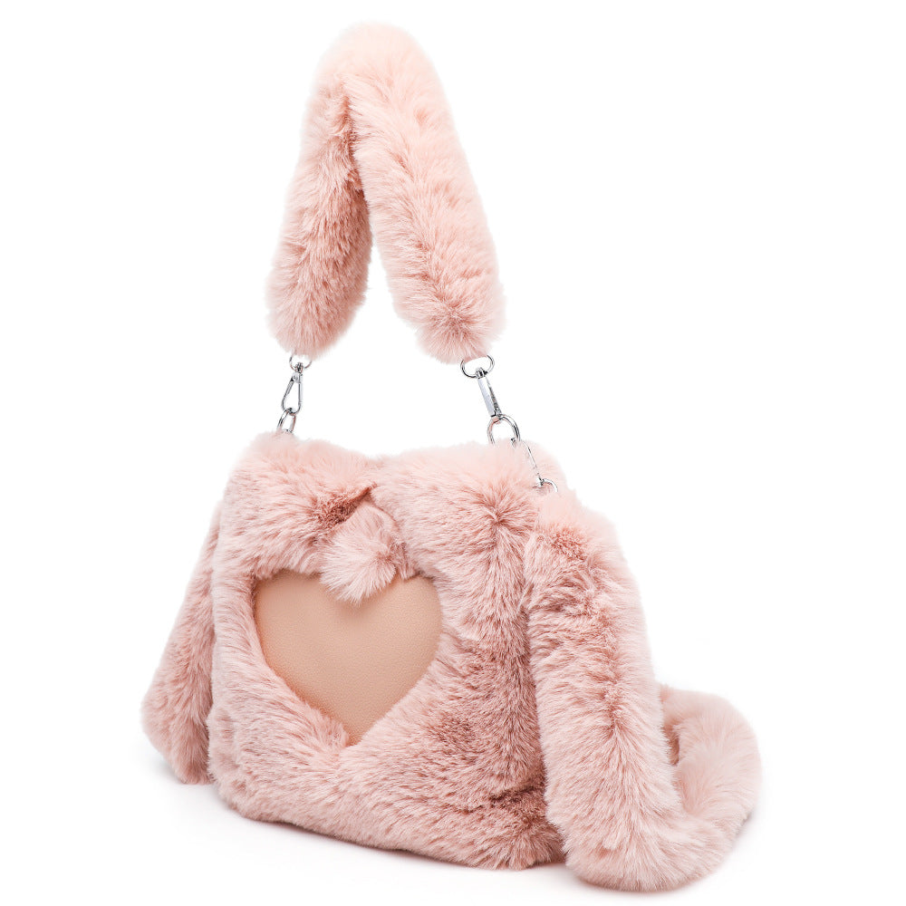 Pink fluffy handbag with bunny ears on a white background