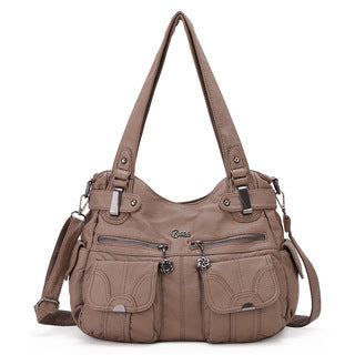 Brown handbag with multiple pockets and straps on a white background