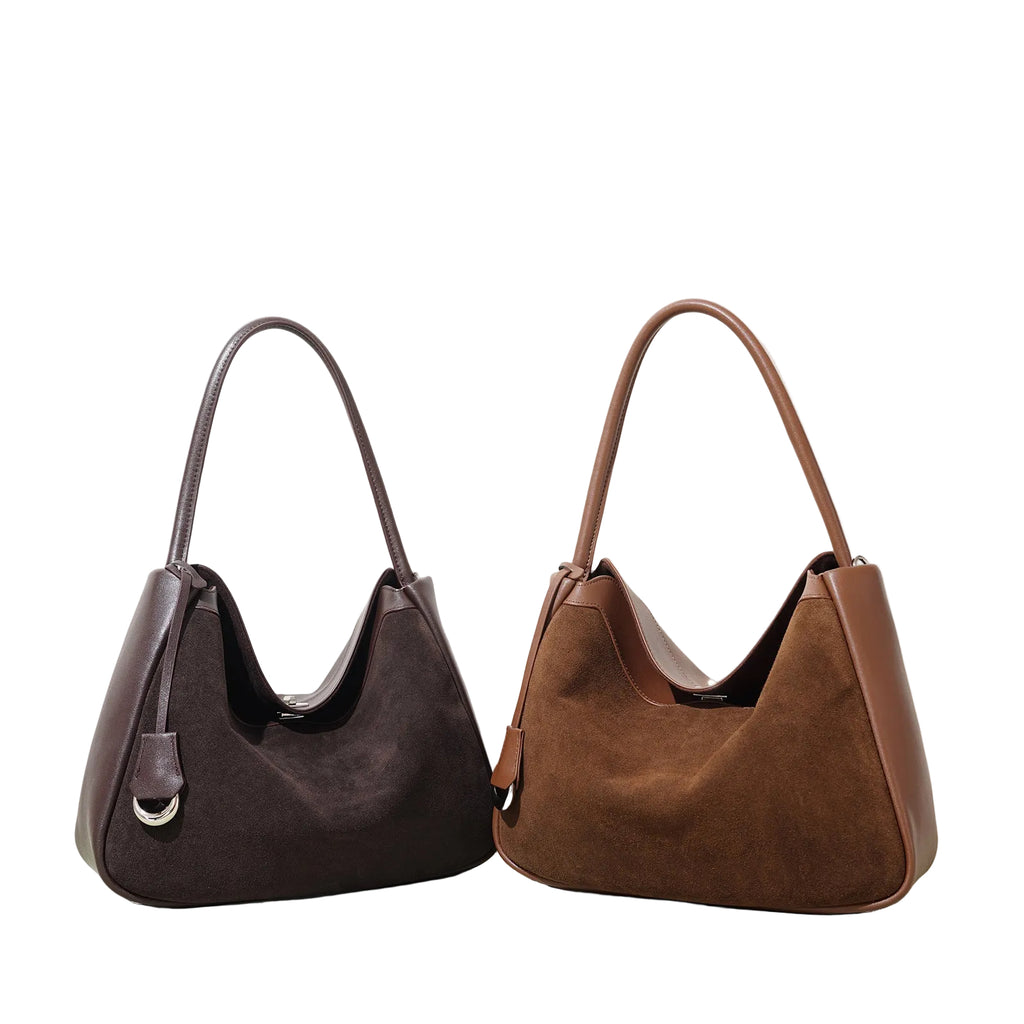 Two handbags, one brown and one black, on a light background
