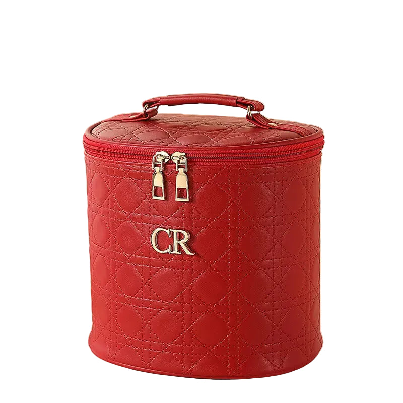 Red quilted makeup bag with 'CR' initials on a white background