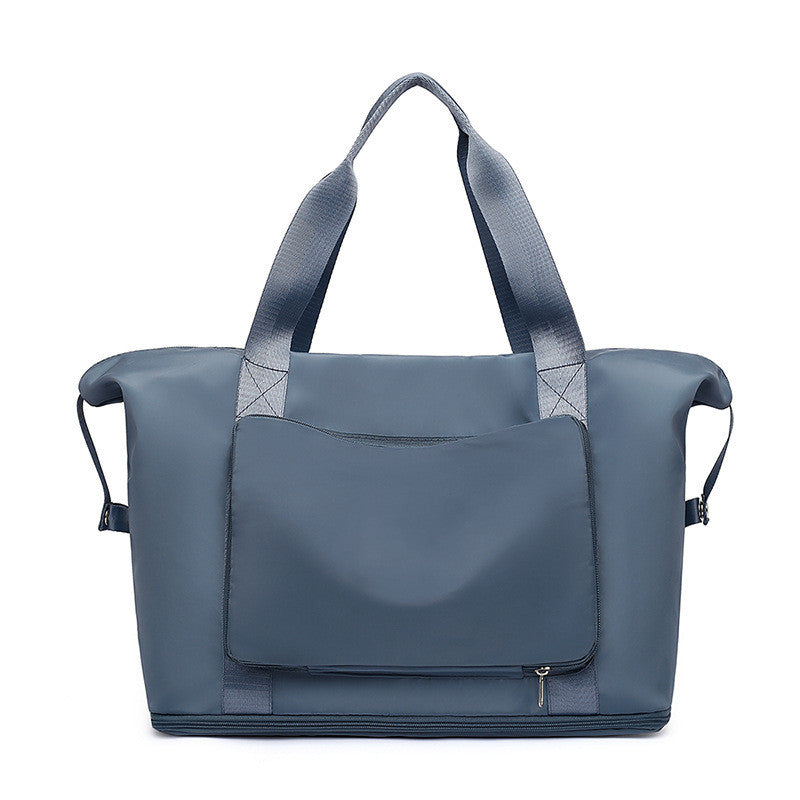 Blue tote bag with a flap closure on a white background