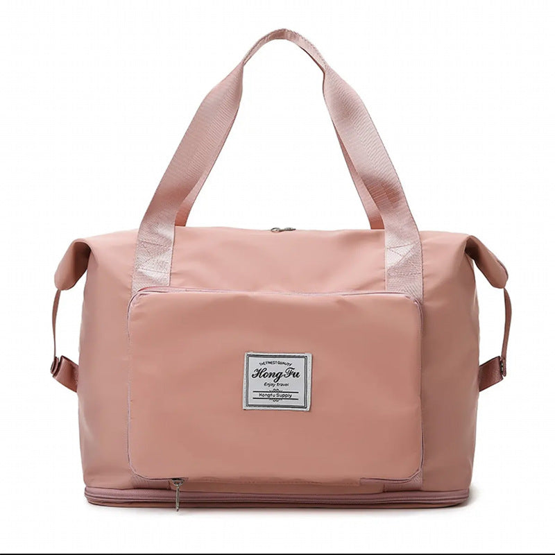 Pink travel bag with a visible brand label on a white background