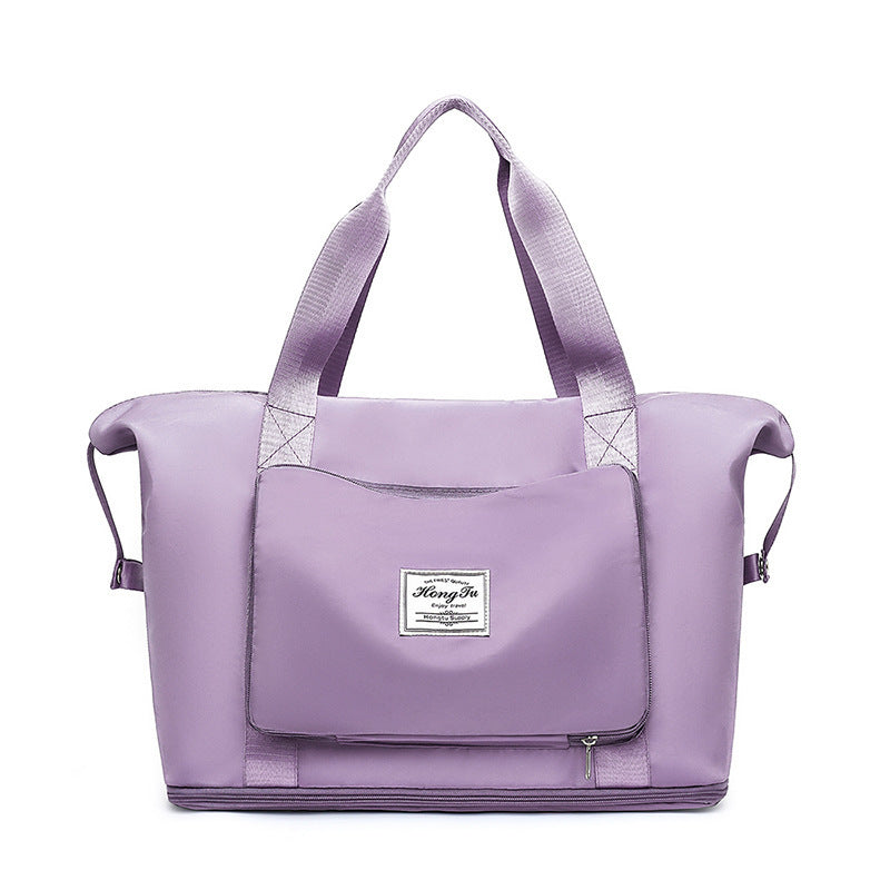 Purple tote bag with a visible brand label on a white background